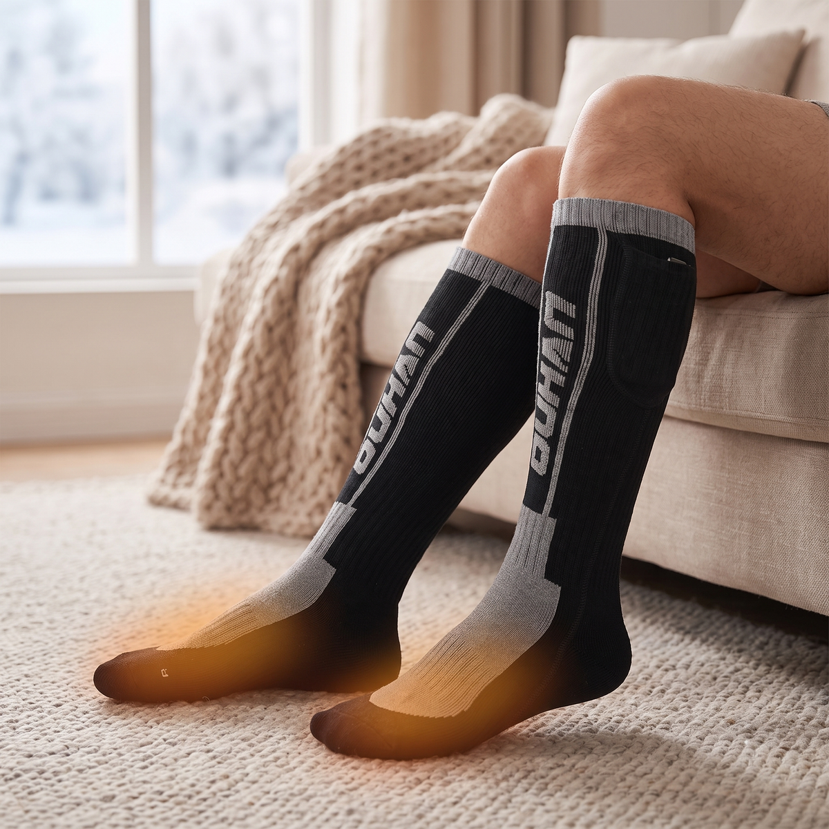 Black and grey knee-high heated socks worn at home