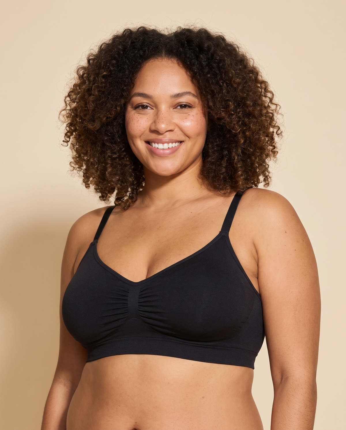 Woman wearing a black wireless ruched pullover bra