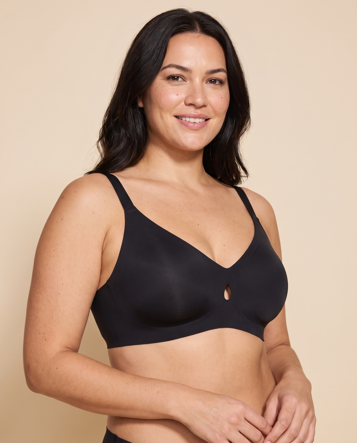 Woman wearing a black wireless V neck jelly bra with a small keyhole cut out