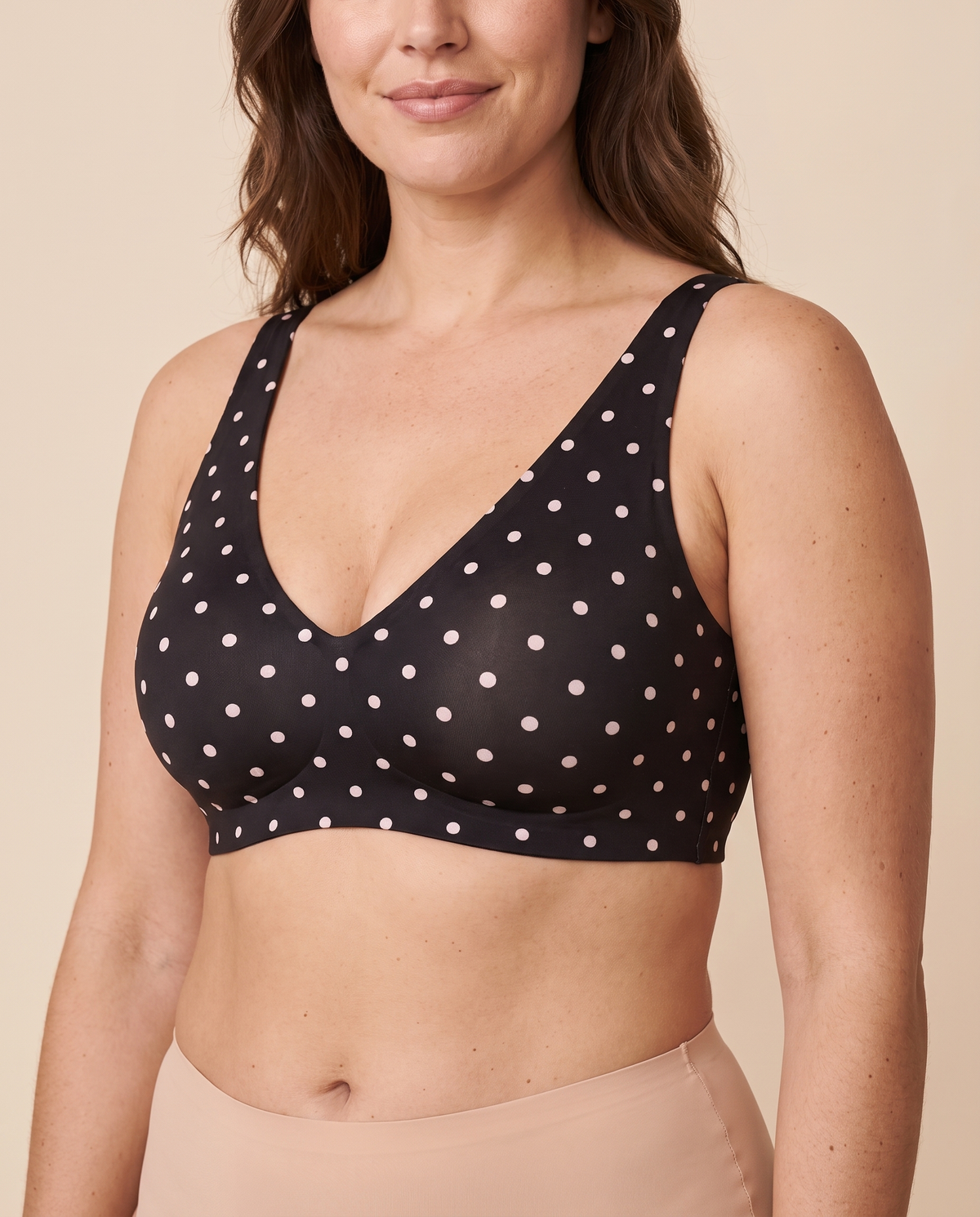 Black polka dot wireless plunge bra worn by a model