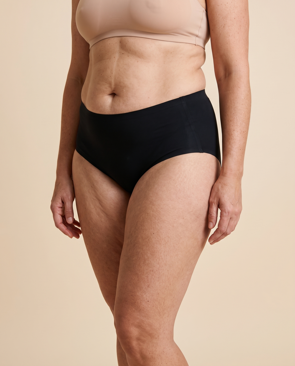 Woman wearing black high waisted seamless knickers, front view