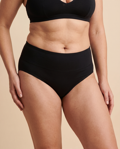 Woman wearing black cotton full brief knickers, front view