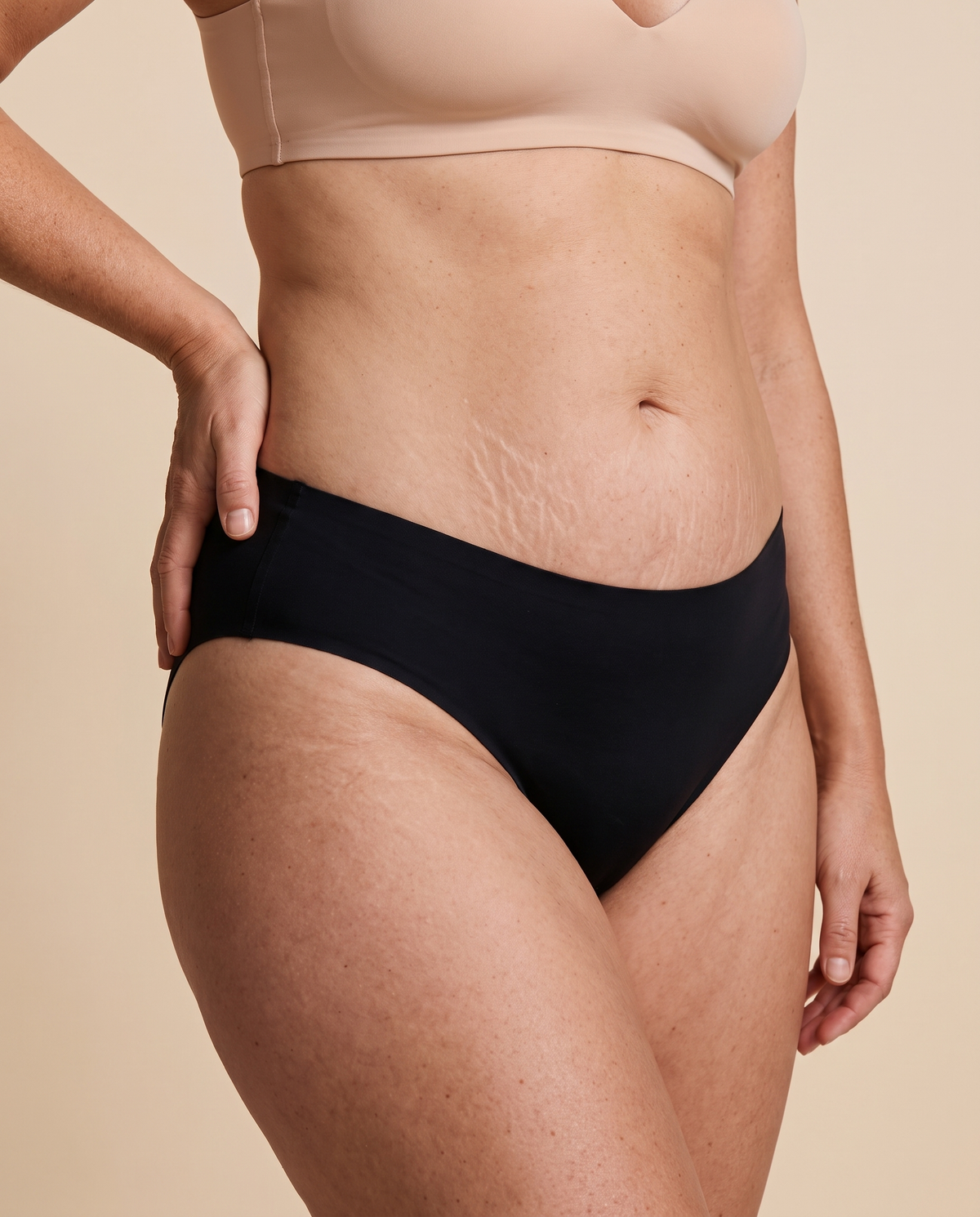 Woman wearing black seamless mid rise knickers, front view