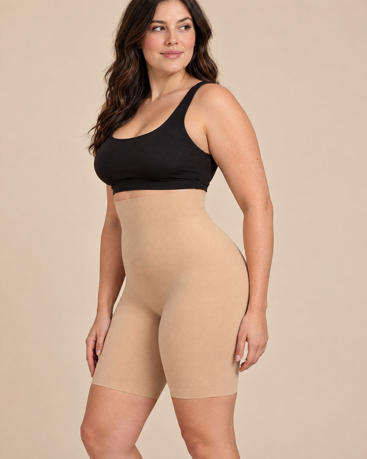 Woman wearing nude high waisted shapewear shorts, side view showing the mid thigh length